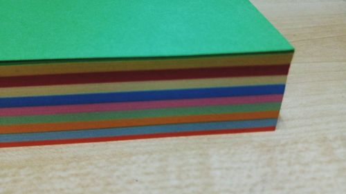 High angle view of multi colored paper on table