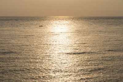 Scenic view of sea against clear sky during sunset