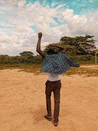 Rear view of woman standing on ground