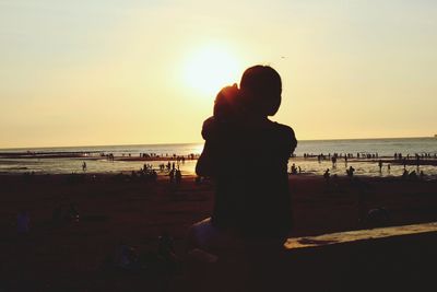 People on beach at sunset