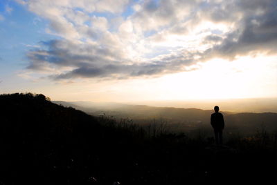 Silhouette man on landscape against sky