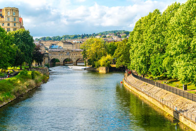 Arch bridge over river against sky