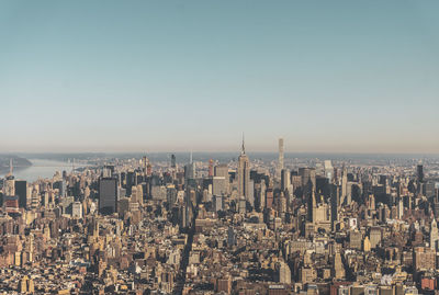 Aerial view of city buildings against clear sky