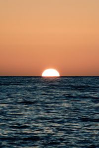 Scenic view of sea against orange sky
