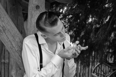 Portrait of man smoking outdoors