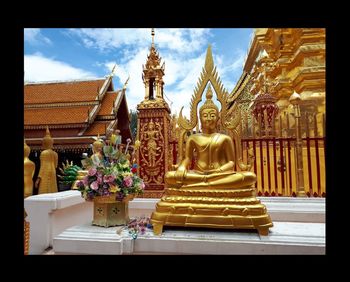 Statue outside temple against building