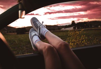 Low section of woman legs in car