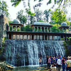 People at fountain in front of building