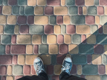 Low section of man standing on footpath