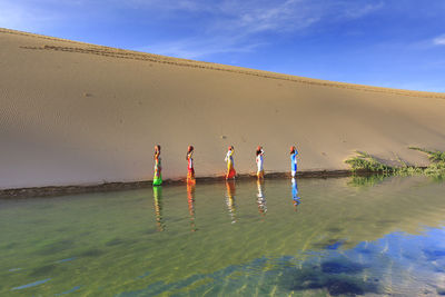 View of people on beach against sky