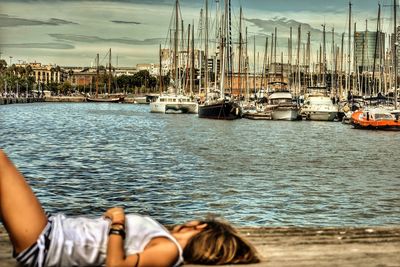 Rear view of woman relaxing at harbor