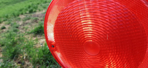 High angle view of red umbrella on field