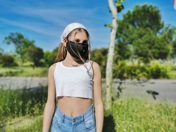 Woman wearing sunglasses standing on field