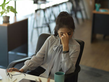 Depressed businesswoman sitting at office