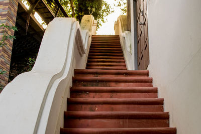 Low angle view of staircase amidst buildings