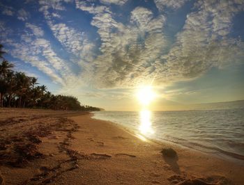 Scenic view of beach against sky during sunset