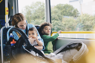 Portrait of friends sitting by window