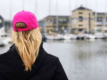 Rear view of woman standing against built structure