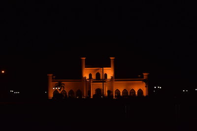 Silhouette of building against sky at night