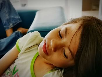 Portrait of woman lying on bed at home