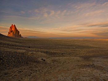 Scenic view of desert against sky during sunset