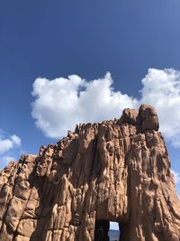 Low angle view of rock formations against sky