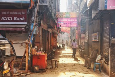 People on street amidst buildings in city