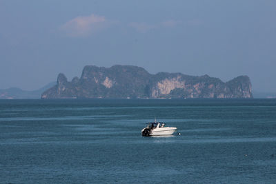 Boat sailing on sea against sky