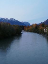 Scenic view of lake and mountains against clear sky