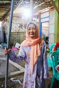 Portrait of smiling senior woman sitting outdoors