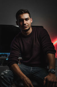 Portrait of young man sitting outdoors