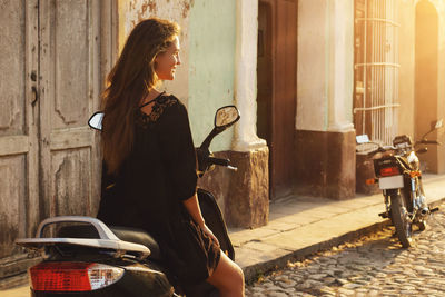 Rear view of young woman using mobile phone