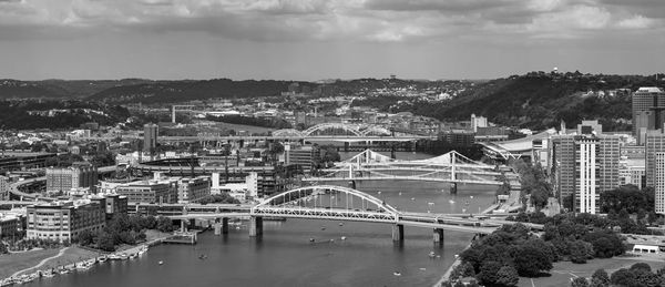 High angle view of bridge over river amidst buildings in city