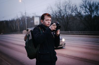 Full length of man photographing in winter