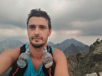 Portrait of smiling man against mountains