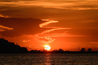 Scenic view of sea against romantic sky at sunset