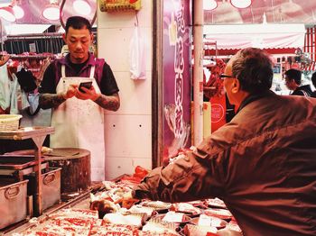 People working at market stall