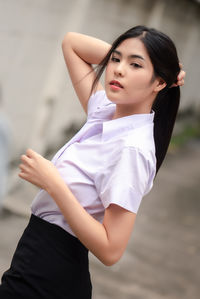 Portrait of young woman standing outdoors