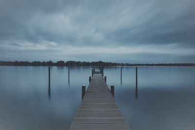 Pier over lake against sky