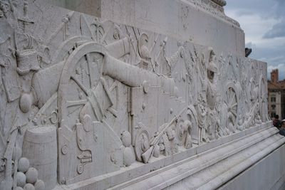 Old sculpture against sky