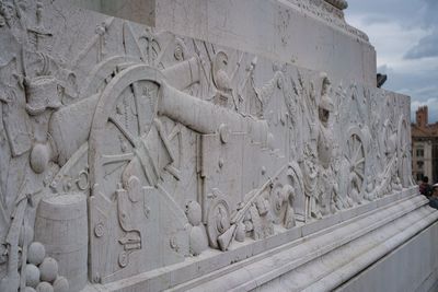 Old sculpture against sky