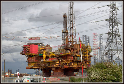 Commercial dock by sea against sky