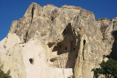 Low angle view of rock formation against clear sky