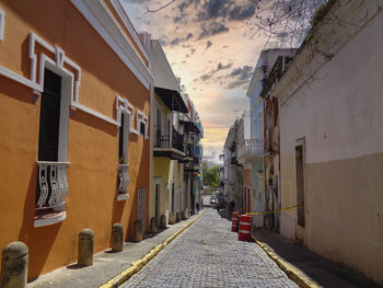 Empty alley amidst buildings in city