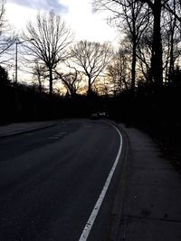 Empty road along trees