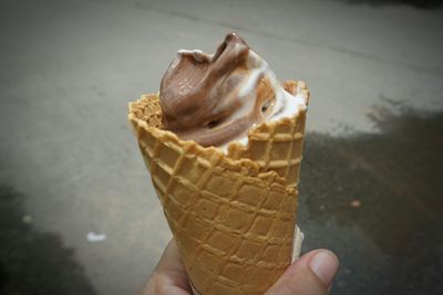 Close-up of hand holding ice cream cone