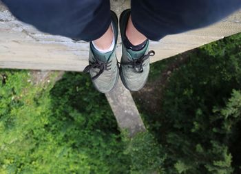 Nike on feet hanging down. afraid of hight, personal view, nature