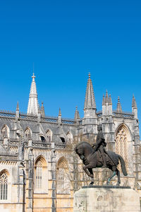 Low angle view of historical building against clear blue sky