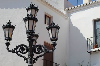 Low angle view of street light against building
