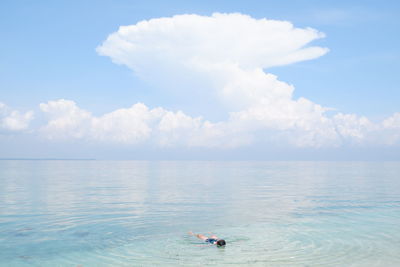 High angle view of woman swimming in sea